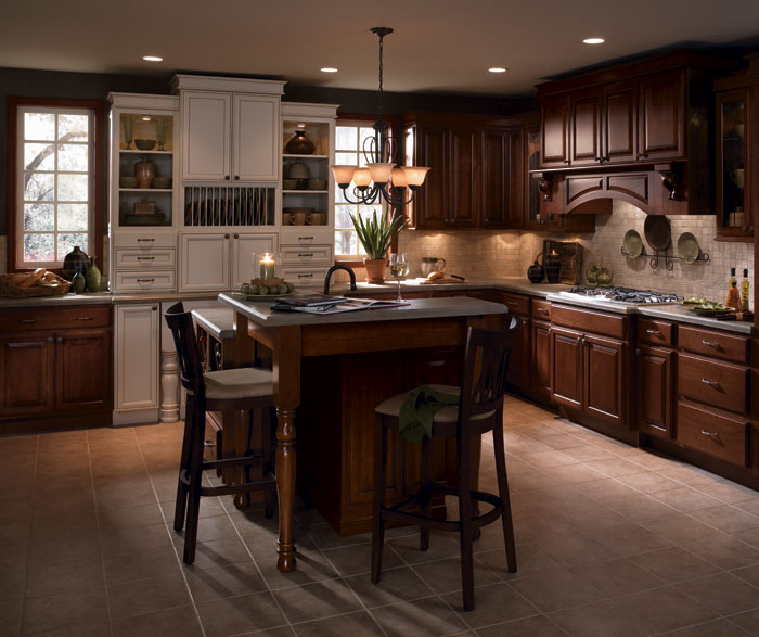 Cherry wood kitchen cabinets with laminate accents by Diamond Cabinetry